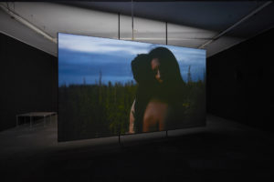Shannon Te Ao, With the sun aglow, I have my pensive moods, 2017 (installation view). Two channel video, colour and sound cinematography by Iain Frengley. Commissioned by Edinburgh Art Festival and Te Tuhi, Aotearoa New Zealand. Photo by Sam Hartnett, courtesy of Mossman, Wellington.