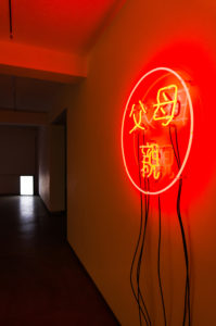 Teng Chao-Ming, Becoming a different person, 2011 (installation view). Red neon, three separate power switches, 730mm diameter.