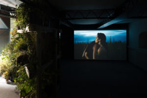 Shannon Te Ao, With the sun aglow, I have my pensive moods, 2017 (install view). Two channel video, colour and sound cinematography by Iain Frengley. Commissioned by Edinburgh Art Festival and Te Tuhi, Aotearoa New Zealand. Courtesy of Mossman, Wellington. Photo by Johnny Barrington.