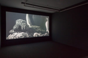 Shannon Te Ao, A torch and a light (cover), 2015 (installation view). Single-channel video and sound 7 mins 33 secs looped cinematography by Iain Frengley featuring text from ‘He waiata aroha’ (A song of love), author unknown, trans. Heni Turei and Materoa Ngarimu. Photo by Sam Hartnett courtesy of Mossman, Wellington.