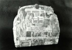 Lillian Budd, Aids Bag, 1990. Photocopied text, epoxy resin on hand bag. 230mm x 270mm x 50mm. Courtesy of Budd Archive, Cubewell House, Wellington, and Gregory Flint Gallery, Auckland.