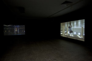 Shaun Gladwell, Double Voyage, 2006 (installation view). Dual channel video installation, mirror. Courtesy of Anna Schwartz Gallery, Melbourne. Photo by Sam Hartnett.