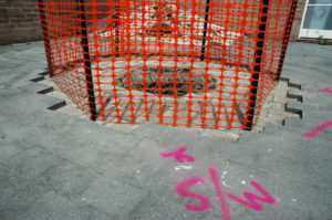 Maddie Leach, Andalucía, 2007 (installation view). Excavated hole (1m x 2m), earth, tarpaulin, fencing mesh & waratahs.