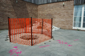 Maddie Leach, Andalucía, 2007 (installation view). Excavated hole (1m x 2m), earth, tarpaulin, fencing mesh & waratahs.