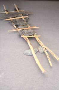 Chris Booth, Stretcher, Te Pahi Island, 1986 (installation view). Kanuka, bronze, basalt.