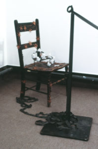 Deborah Smith, Singe, 1991 (detail). Laser prints, curtain, stanchions, chair, candles.
