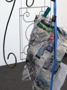 Kah Bee Chow, Portals, 2022 (detail). Vinyl, steel, fruit, plastic stool, raffia, plastic bags, plastic sheets, lurex, dried bamboo leaves, dried lotus leaf, organza, thread, laundry clips, hangers, newspaper, straw, paper clips, ties, clips, wire, rubber bands, s-hooks, compact disc, net, hair clip, fruits, found objects. Dimensions variable. Commissioned by Te Tuhi, Tāmaki Makaurau Auckland. Photo by Sam Hartnett.