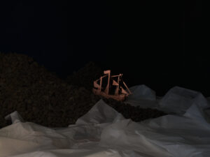 Harrison Freeth and Benjamin Work, Bodies of Water, Made of Land 2023 (installation view) copper, archival paper, volcanic rock, video projection Commissioned by Te Tuhi (Tāmaki Makaurau, Auckland) photography credit Samuel Hartnett