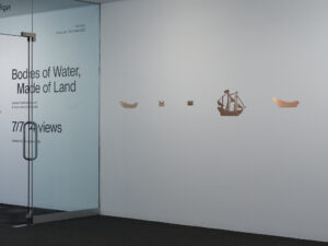 Harrison Freeth and Benjamin Work, Bodies of Water, Made of Land 2023 (installation view) copper, archival paper, volcanic rock, video projection Commissioned by Te Tuhi (Tāmaki Makaurau, Auckland) photography credit Samuel Hartnett