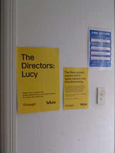 Screening location signage and educational print material for The Directors: Lucy, Marcus Coates, 2022 Yellow Brick Road, Tāmaki Makaurau, 2024. Photo by Sam Hartnett.